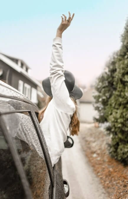 woman rising hand on vehicle window