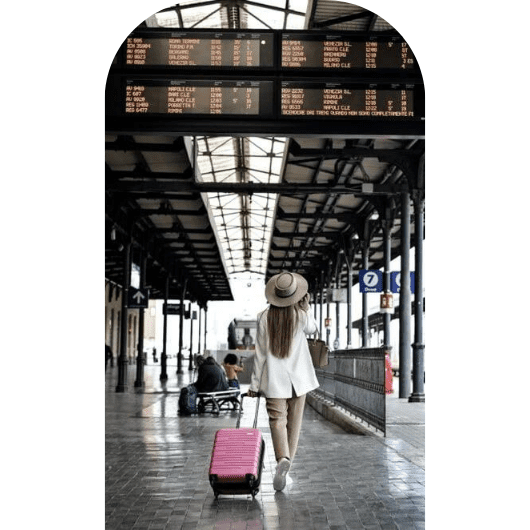 woman holding pink luggage