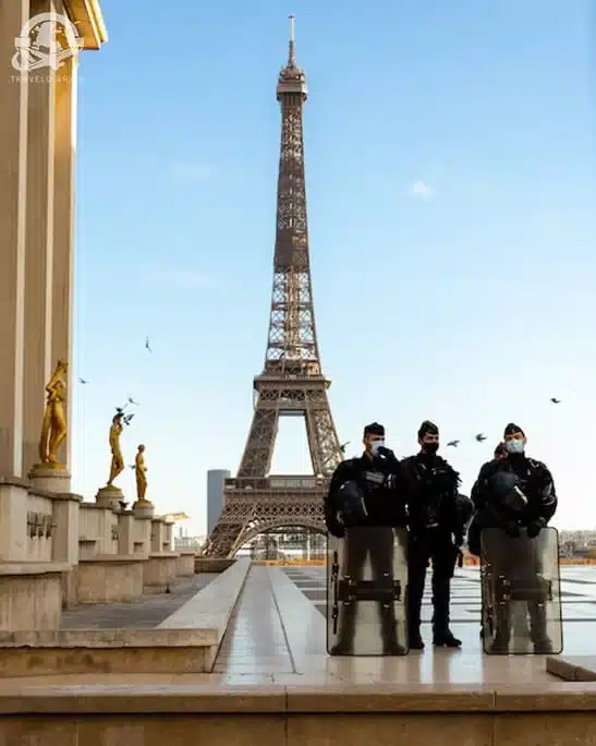 people wearing face masks at Eiffel tower, Paris
