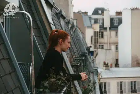 0. woman in a black long-sleeve shirt standing in a window of Airbnb during daytime; Paris, France